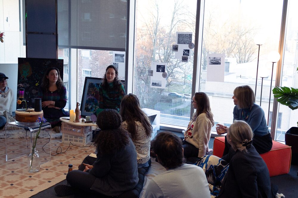 Participants seated in a circle, listening, during a New Social Forms salon