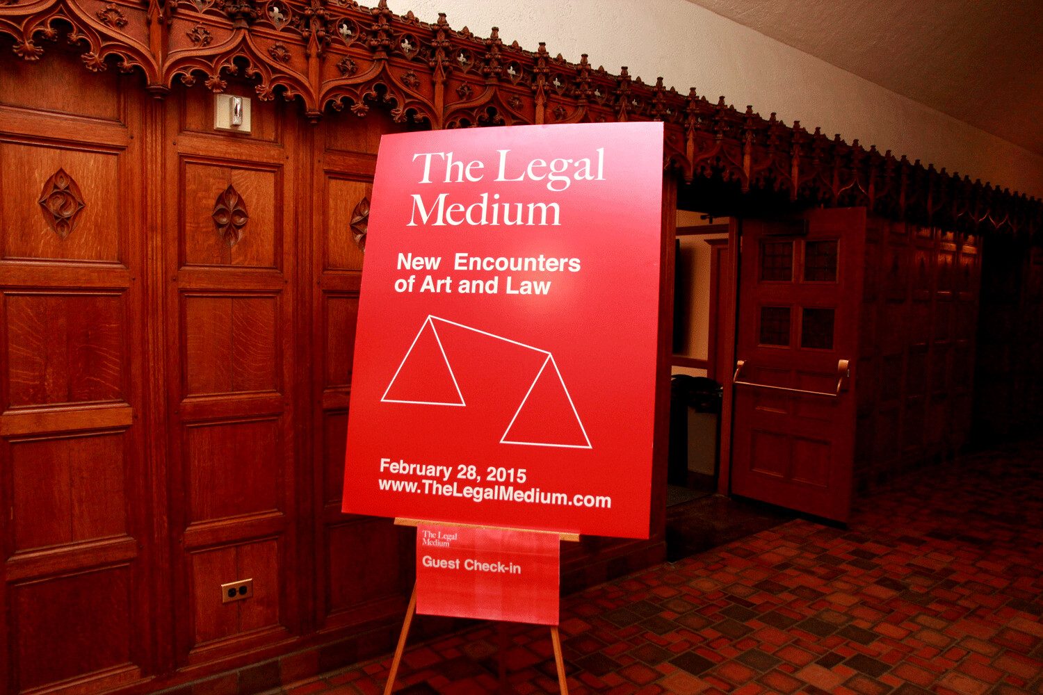 The red welcome sign for The Legal Medium in the panelled hall at Yale Law School