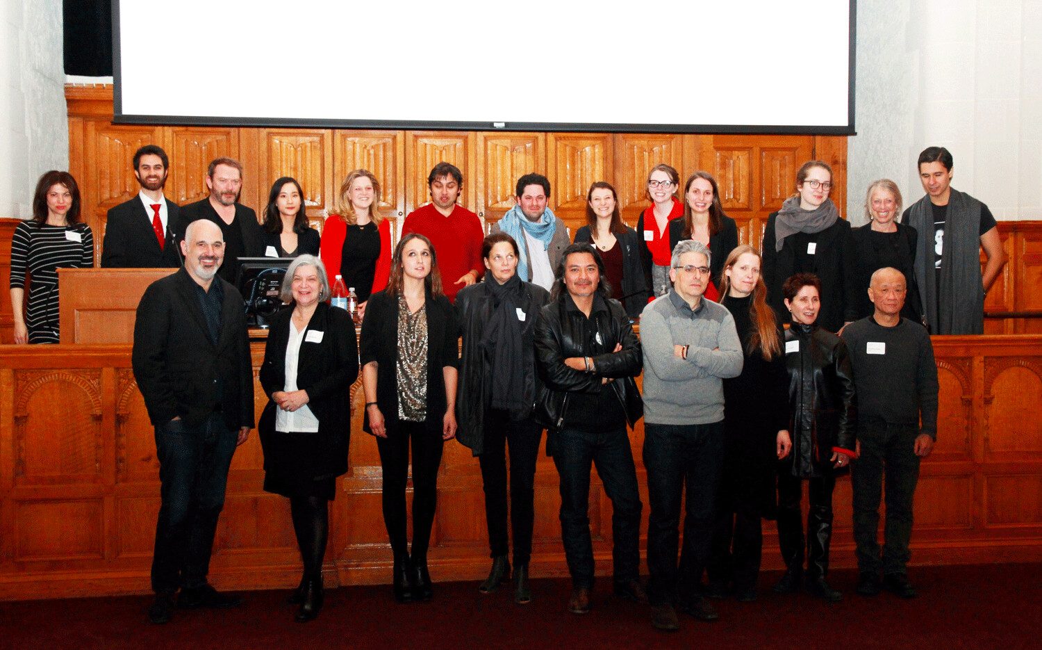 Group portrait of the organisers and panellists on the courtroom bench