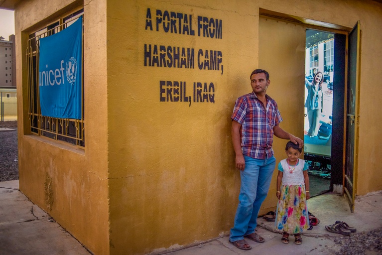 A father and daughter at a Portal in Erbil